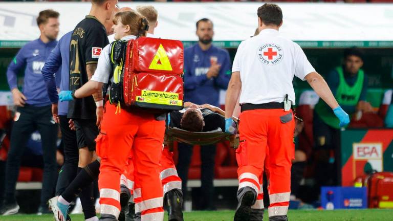 Augsburg’s German midfielder #19 Robin Fellhauer is stretchered off following a clash of heads during the German first division Bundesliga football match between FC Augsburg and FC Bayern Munich. - Michaela STACHE / AFP