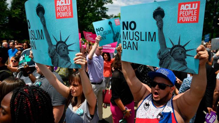 FILEpix: People protest the Muslim travel ban in front of the US Supreme Court in Washington, DC on June 26, 2018. US President Donald Trump signed a new travel ban June 4, 2025 targeting 12 countries, saying it was spurred by an attack on a Jewish protest in Colorado that authorities blamed on a man they said was in the country illegall. AFP