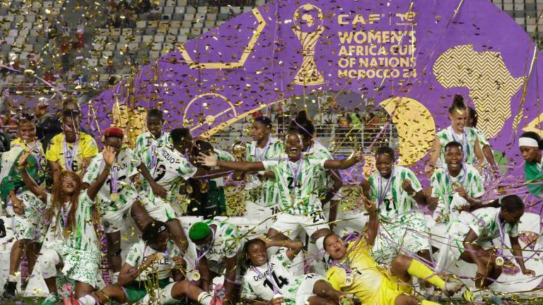 Nigeria’s players celebrate with the trophy on the podium after winning the 2025 Women’s Africa Cup of Nations final football match against Morocco at Prince Moulay Abdellah Stadium in Rabat on July 26, 2025. Photo by Abdel Majid BZIOUAT / AFPpix