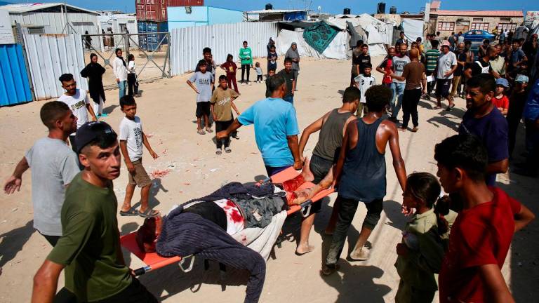 A Palestinian man who was injured while seeking humanitarian aid at the Rafah corridor, is carried into a field hospital in the Mawasi area of Rafah in the southern Gaza Strip on July 30, 2025. - AFPpix