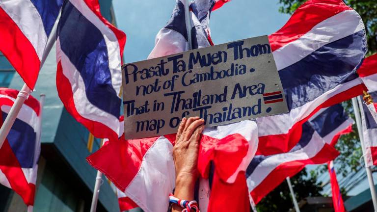 A royalist activist holds a placard as she protests in front of the Royal Embassy of Cambodia, following a recent clash at the Thailand-Cambodia border on May 28, 2025, in Bangkok, Thailand, June 6, 2025. - REUTERSPIX