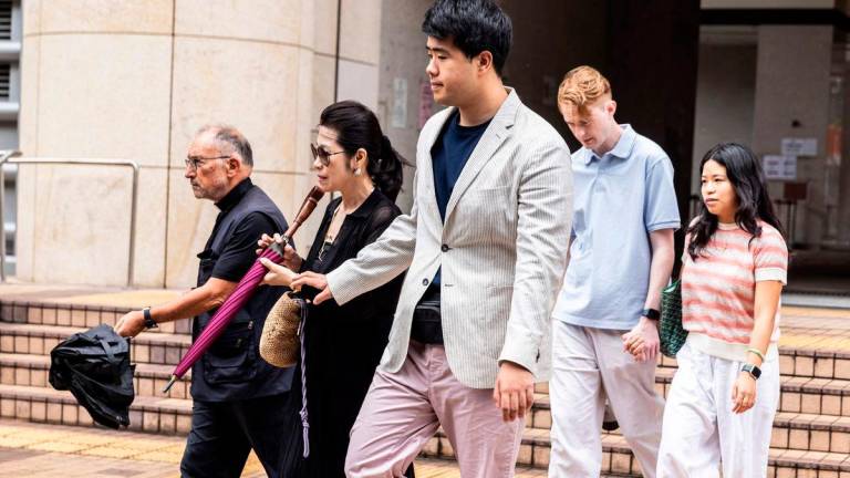 Jimmy Lai’s wife Teresa Lai (2nd L) and their son Lai Shun Yan (R) leave the West Kowloon court where Lai’s national security trial is being held in Hong Kong on August 15, 2025. AFPPix