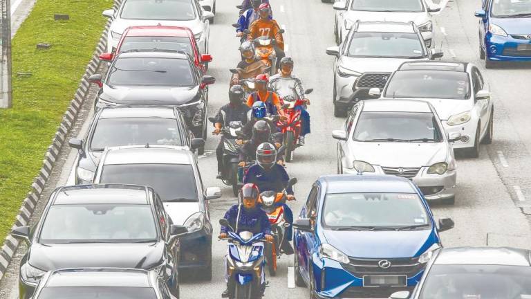 Motorcyclists should remain on the left side of roads instead of riding between cars. – ADAM AMIR HAMZAH/THESUN