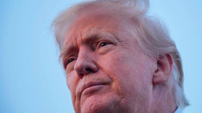 U.S. President Donald Trump looks on as he talks to members of the press at Lehigh Valley International Airport in Allentown, Pennsylvania, U.S., August 3, 2025. REUTERS/Ken Cedeno