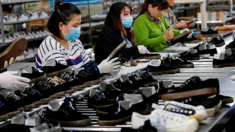 Employees work at a shoe factory for export in Hanoi, Vietnam December 29, 2020. REUTERS