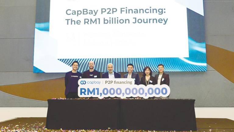 From left: CapBay directors Darrel Ang, Dion Tan and Mohd Mokhtar Shariff, CEO Ang Xing Xian, directors Jasmine Lau and Edwin Tan marking the RM1 billion P2P financing milestone.