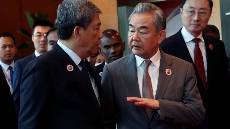Malaysia’s Foreign Minister, Datuk Seri Mohamad Hasan, welcomes his counterpart from China, Wang Yi, at the ASEAN Post-Ministerial Conference with China - Bernamapix