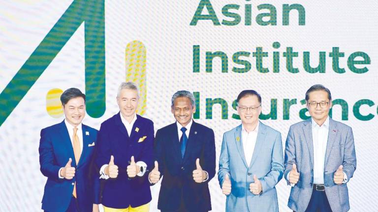 Abdul Rasheed (centre), Asian Institute of Insurance chairman Antony Lee (second from left) and CEO Paul Low (second from right) at the rebranding ceremony. – Bernamapic