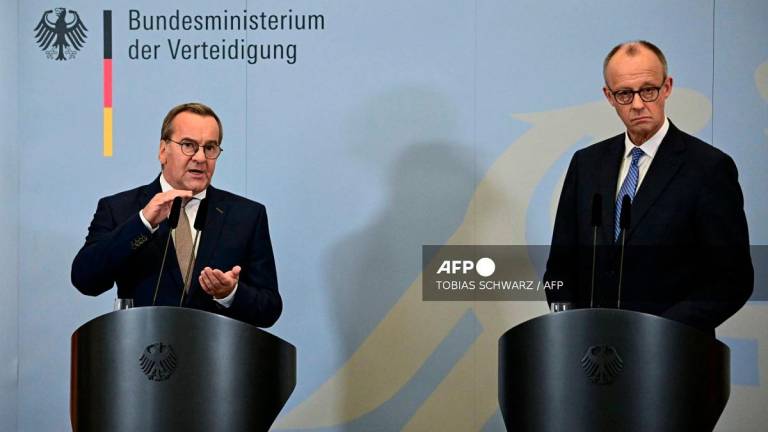 German Chancellor Friedrich Merz (R) listens as German Defence Minister Boris Pistorius addresses a joint press conference following a cabinet meeting held exceptionally at the Bendlerblock, seat of the Federal Ministry of Defence, in Berlin on August 27, 2025. - Tobias SCHWARZ / AFP