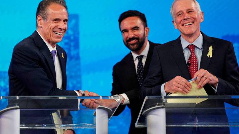 Democratic mayoral candidates Andrew Cuomo shakes hands with Zohran Mamdani as Whitney Tilson reacts, after participating in a Democratic mayoral primary debate - Yuki Iwamura/Pool via REUTERSpix
