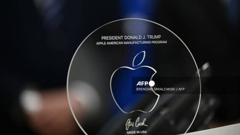 A memento presented by Apple CEO Tim Cook is seen on the Resolute Desk in the Oval Office of the White House in Washington, DC, on August 6, 2025 before announcing that Apple will invest an additional $100 billion in the United States, taking its total pledge to $600 billion over the next four years. - AFP