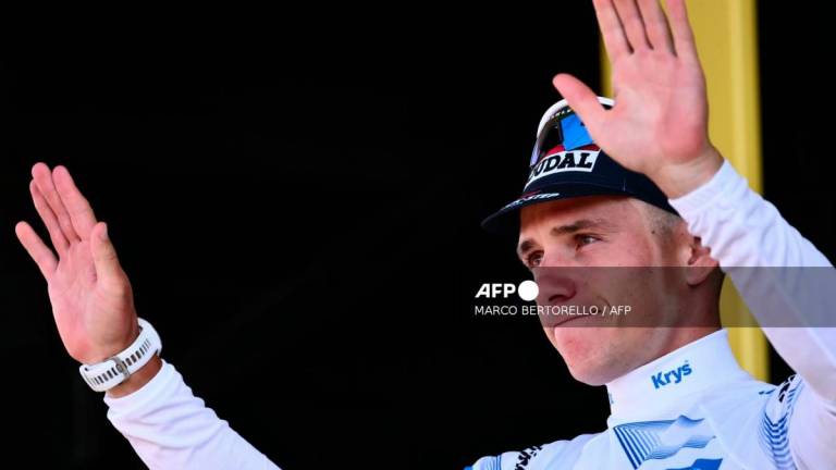Soudal Quick-Step team's Belgian rider Remco Evenepoel celebrates on the podium with the best young rider's white jersey after the 13th stage of the 112th edition of the Tour de France cycling race, 10.9 km individual time trial between Loudenvielle and Peyragudes, in the Pyrenees mountains of southwestern France, on July 18, 2025. - AFPPIX