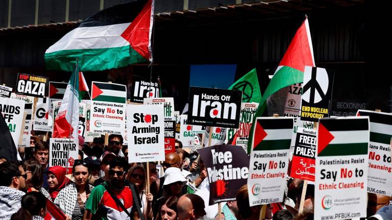 Pro-Palestinian supporters gather in Russell Square to take part in a march through central London, on June 21, 2025, at a demonstration organised by the Palestinian Solidarity Campaign, calling for “No War On Iran”, “Stop Arming Israel”, “Stop Starving Gaza” and an end to “the Genocide”. - BENJAMIN CREMEL / AFP
