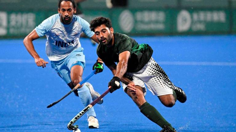 Pakistan's Abdul Waheed Ashraf Rana (R) controls the ball as India's Hardik Singh looks on during the preliminary men's pool hockey match between India and Pakistan at the 2022 Asian Games in Hangzhou in China's eastern Zhejiang province on September 30, 2023. - AFPPIX