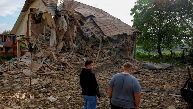 Resident Vadym Tsybenko, 22-year-old, and his relative stands next a house of his neighbours, heavily damaged by a Russian drone strike, amid Russia’s attack on Ukraine, outside of Kyiv, Ukraine. REUTERSpix