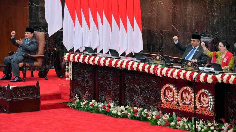 Indonesian President Prabowo Subianto (L) gestures with Puan Maharani (R), speaker of the People’s Representative Council of Indonesia and Ahmad Muzani (C), speaker of People’s Consultative Assembly, before delivering his annual State of the Nation Address, ahead of the country’s Independence Day in Jakarta on August 15, 2025. Photo by BAY ISMOYO / POOL / AFP