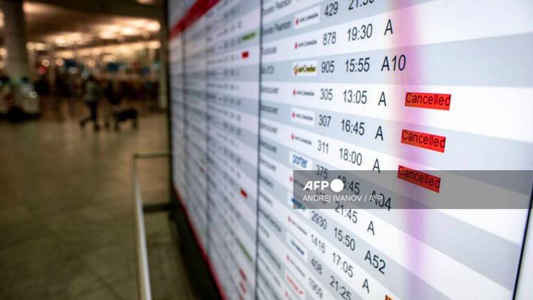 A flight board is seen with many cancellations for Air Canada flights at Pierre-Elliott Trudeau Airport in Montreal, Quebec, Canada, on August 17, 2025. (Photo by ANDREJ IVANOV / AFP)