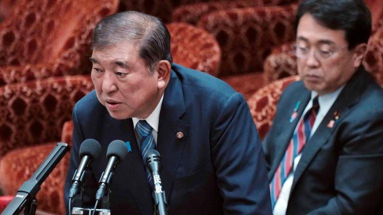 Japan's Prime Minister Shigeru Ishiba (L) and Economic Revitalization Minister and chief negotiator in trade tariff talks Ryosei Akazawa (R) attend a budget committee session on the US tariff issue in the House of Representatives at the Parliament in Tokyo on August 4, 2025. - AFPPIX