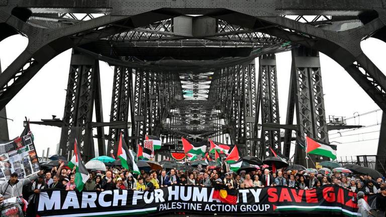 Protesters walk across the Sydney Harbour Bridge during the Palestine Action Group’s March for Humanity in Sydney, Australia, August 3, 2025. AAP/Dean Lewins via REUTERS