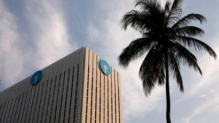 FILE PHOTO: FILE PHOTO: The logo of State Bank of India (SBI) is seen on the facade of its headquarters in Mumbai, India, April 12, 2023. REUTERS/Niharika Kulkarni/File Photo/File Photo