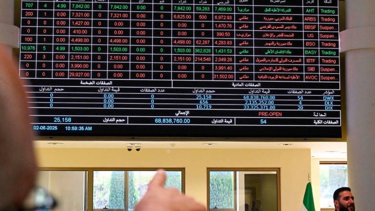 A man points at a trading board displaying the latest numbers at the Damascus Secutiries Exchange (DSE) as Syria’s stock market opens the Ya’fur area near Damascus on June 2, 2025. - LOUAI BESHARA / AFP