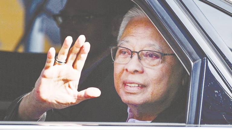 Ismail Sabri Yaakob waving to reporters as he arrives at the MACC headquarters in Putrajaya yesterday. – AFPPIX