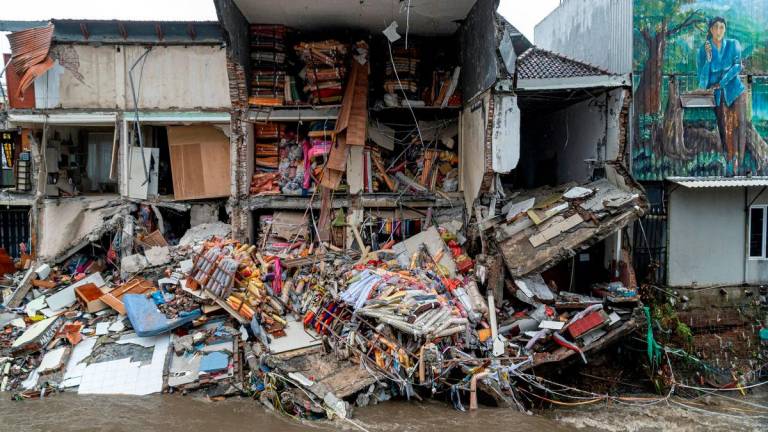 Goods lie scattered at a fabric store that collapsed after being hit by floods following overnight heavy rains in Denpasar, Bali, Indonesia September 10, 2025. REUTERS/Dicky Bisinglasi