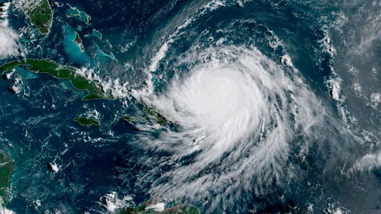Hurricane Erin, which is the first hurricane of the 2025 Atlantic season and has been downgraded to Category 3, moves westward near Puerto Rico in a composite satellite image August 17, 2025. - CIRA/NOAA/Handout via REUTERSPIX