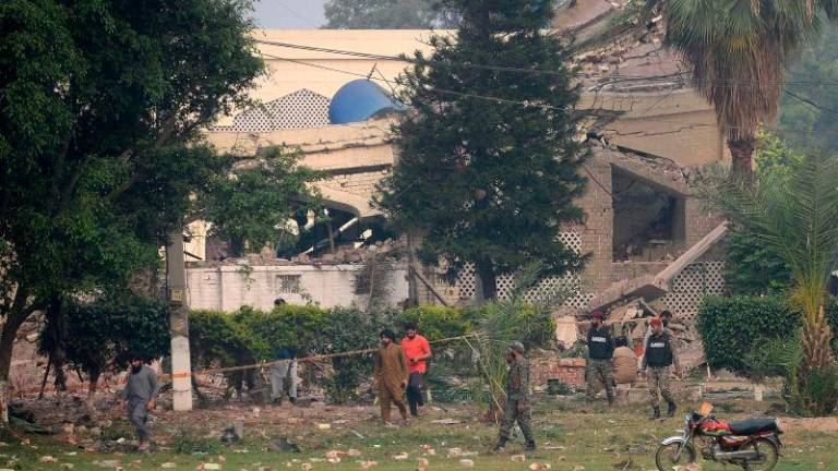 Paramilitary soldiers inspect a collapsed building of the Government Health and Educational complex after Indian strikes in Muridke, about 30 kilometres from Lahore, on May 7, 2025. AFPpix