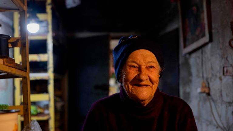 Lidia Isayeva, 86 is walking in the basement where she lives of her heavily damaged building in the town of Lyman, near the frontline in the Donetsk region, on May 7, 2025. AFPpix