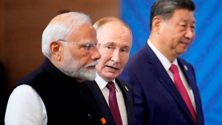Indian Prime Minister Narendra Modi, Russian President Vladimir Putin and Chinese President Xi Jinping attend a family photo ceremony prior to the BRICS Summit plenary session in Kazan. Pool via Reuterspix