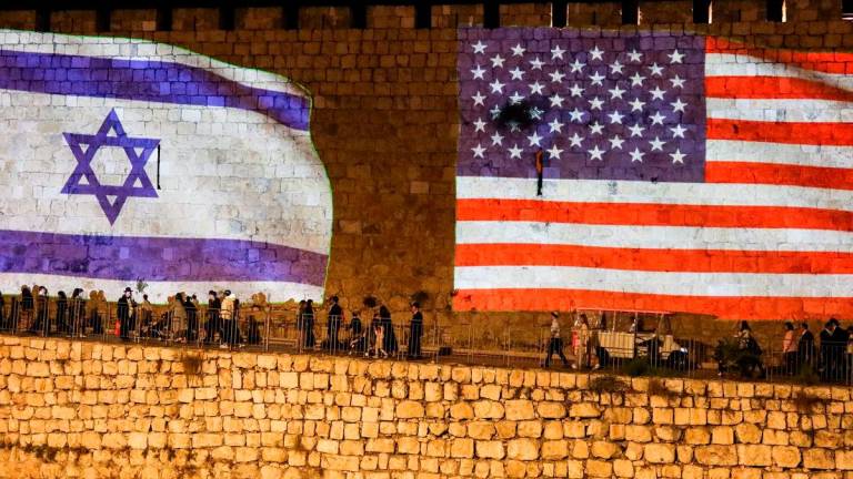 United States and Israel flags are projected on the walls of the Old city of Jerusalem in celebration after Israel and Hamas agreed to the first phase of U.S. President Donald Trump’s plan to end the war in Gaza, October 9, 2025. REUTERS/Sinan Abu Mayzer
