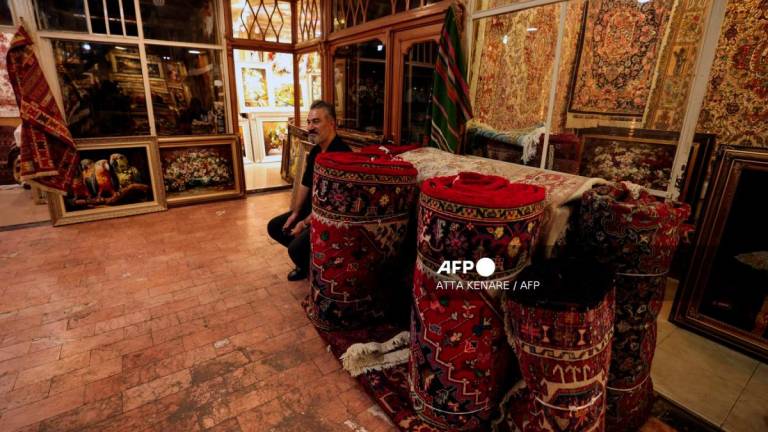 A man sells carpets in Tabriz's historic market, believed to be one of the oldest bazaars in the Middle East, in northwestern Iran, on September 17, 2025. - AFPPIX