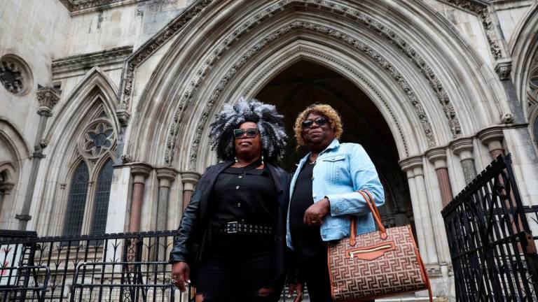 Bertrice Pompe and Bernadette Dugasse stand, following a court injunction that temporarily blocked the UK from concluding Chagos Islands deal with Mauritius, outside the High Court in London, Britain, May 22, 2025. REUTERSpix