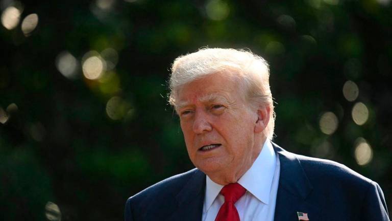 US President Donald Trump speaks to reporters on the South Lawn before boarding Marine One on the South Lawn of the White House - AFPPix