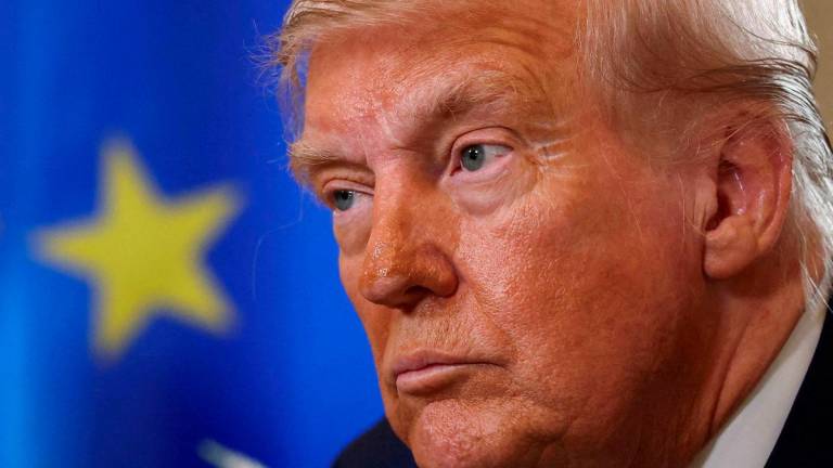 FILE PHOTO: U.S. President Donald Trump looks on during a meeting with European Commission President Ursula von der Leyen (not pictured), after an announcement of a trade deal between the U.S. and EU, in Turnberry, Scotland, Britain, July 27, 2025. REUTERS/Evelyn Hockstein/File Photo