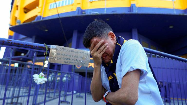 Adalberto Mendoza reacts as people gather to bid farewell to Boca Juniors coach Miguel Angel Russo, who died on Wednesday at the age of 69 after a long battle with cancer, at La Bombonera stadium, in Buenos Aires, Argentina October 9, 2025. REUTERS/Matias Baglietto