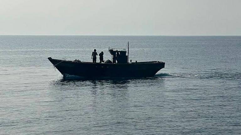 This handout photo taken on July 9, 2025 and provided by South Korean Unification Ministry shows a wooden boat carrying North Korean fishermen crossing the de facto maritime border between South and North Korea in the East Sea - AFP PHOTO / SOUTH KOREAN UNIFICATION MINISTRY