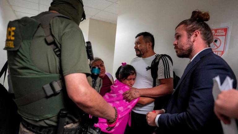 A migrant is embraced by his daughter as he is informed he is going to be detained by federal immigration officers at U.S. immigration court in Manhattan, in New York City, U.S., July 31, 2025. - REUTERSPIX
