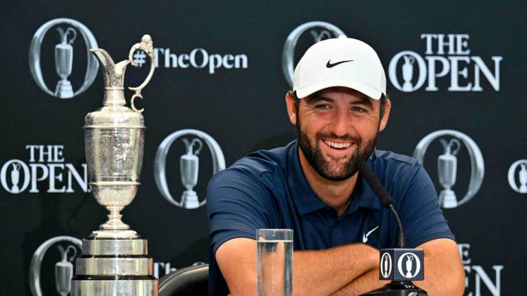 US golfer Scottie Scheffler with the Claret Jug, the trophy for the Champion golfer of the year beside him, holds a press conference after his victory in the 153rd Open Championship at Royal Portrush golf club in Northern Ireland on July 20, 2025 - AFP