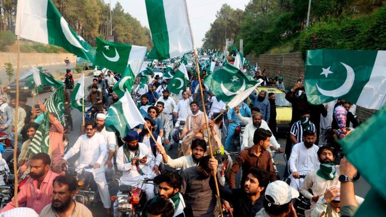 Supporters of Pakistan Markazi Muslim League (PMML) wave flags during a rally in support of Pakistani Army following India’s military strikes on Pakistan, in Islamabad, Pakistan, May 7, 2025. REUTERSpix