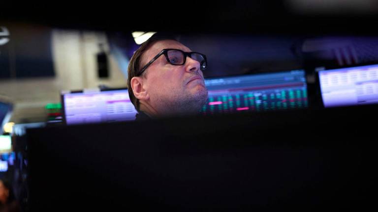 A trader works on the floor of the New York Stock Exchange (NYSE) at the opening bell on August 11, 2025, in New York City. Wall Street stocks opened mixed Monday, ahead of a key US inflation report and as the clock ticked down to a deadline for higher tit-for-tat tariffs to return between Washington and Beijing. - AFPPIX