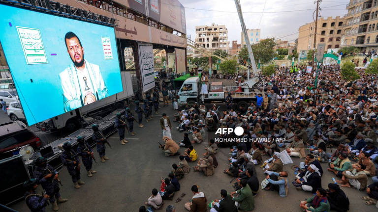 Yemeni Shiite Muslims listen to a speech by Huthi leader Abdul-Malik al-Huthi broadcast on a giant screen during a ceremony commemorating Ashura, a ten-day period to remember and mourn the seventh century killing of Islam’s Prophet Mohammed’s grandson Imam Hussein, in Sanaa, on July 6, 2025. - AFP