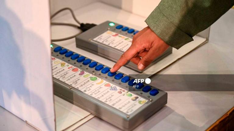 An official shows how to use a voting machine for future elections in Yangon on September 5, 2023. - AFP