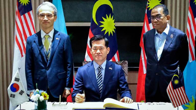 Defence Minister Datuk Seri Mohamed Khaled Nordin (right) witnessing Seok signing a guests book for bilateral talks in conjunction with the Defence Services Asia and National Security Asia 2024 on Tuesday. – Bernamapic