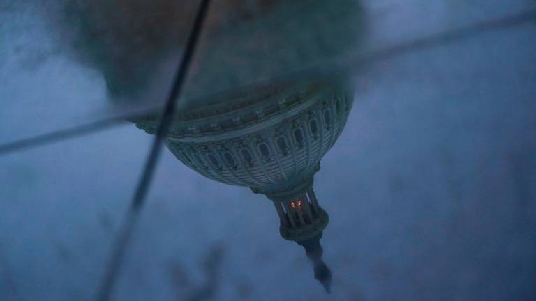 The U.S. Capitol dome is reflected in a puddle on the ground, on the day U.S. President Donald Trump met with top congressional leaders from both parties, just ahead of a September 30 deadline to fund the government and avoid a shutdown, in Washington, D.C., U.S., September 29, 2025. - REUTERSPIX