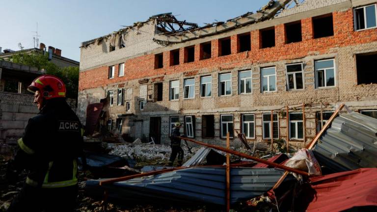 Firefighters work at the site of a building hit by a Russian drone strike, amid Russia’s attack on Ukraine, in the downtown of Kharkiv, Ukraine July 11, 2025.