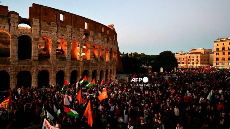 Pro-Palestinian demonstrators gather to support the Palestinians and to protest against the interception of the Global Sumud Flotilla, near the Colosseum in Rome on October 2, 2025. (Photo by Tiziana FABI / AFP)