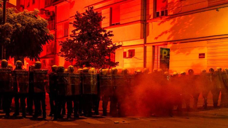 Police officers stand guard during a standoff between ruling party supporters and anti-government protesters in Novi Sad, Serbia. Reuterspix