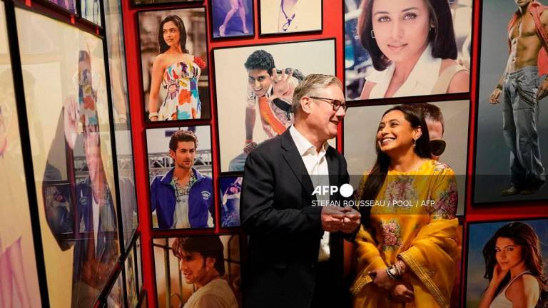 Britain’s Prime Minister Keir Starmer interacts with Indian actress Rani Mukerji during a visit to Yash Raj Films, a Bollywood studio, in Mumbai on October 8, 2025. (Photo by Stefan Rousseau / POOL / AFP)